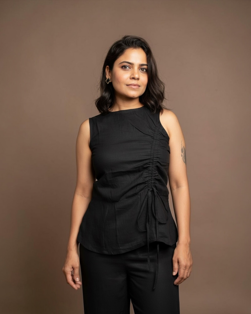 Close-up of black ruched sleeveless top detail