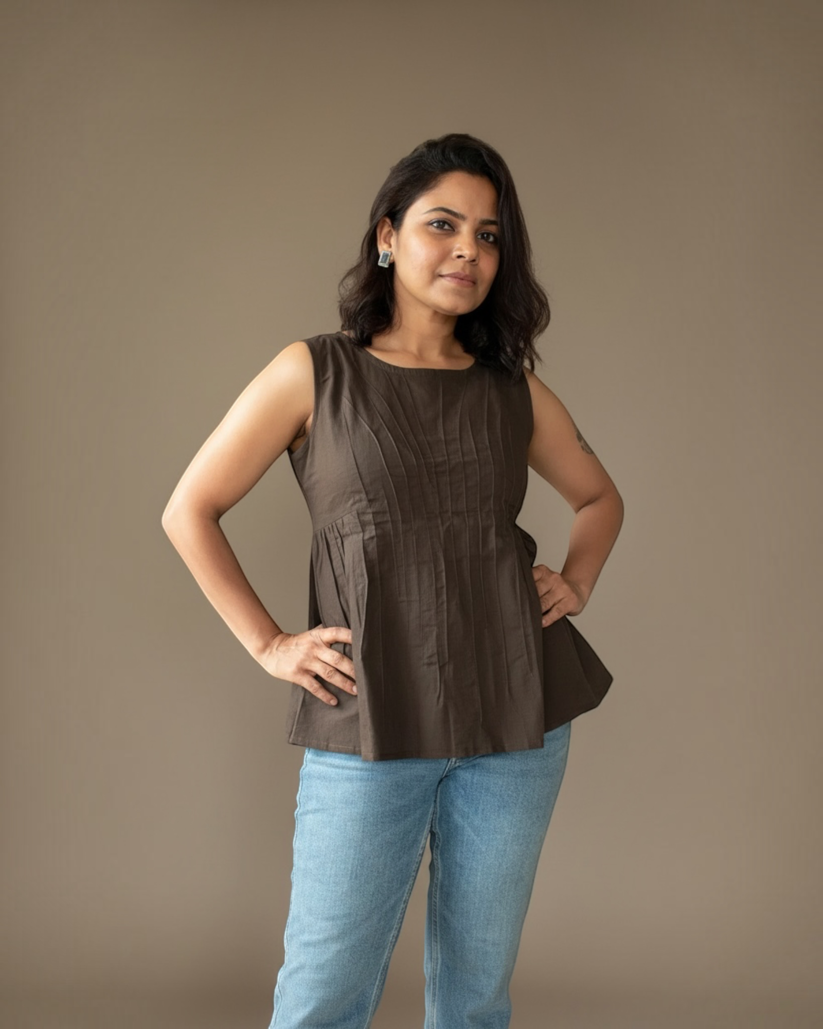 Mocha Pintuck Peplum Top – Confident pose front view